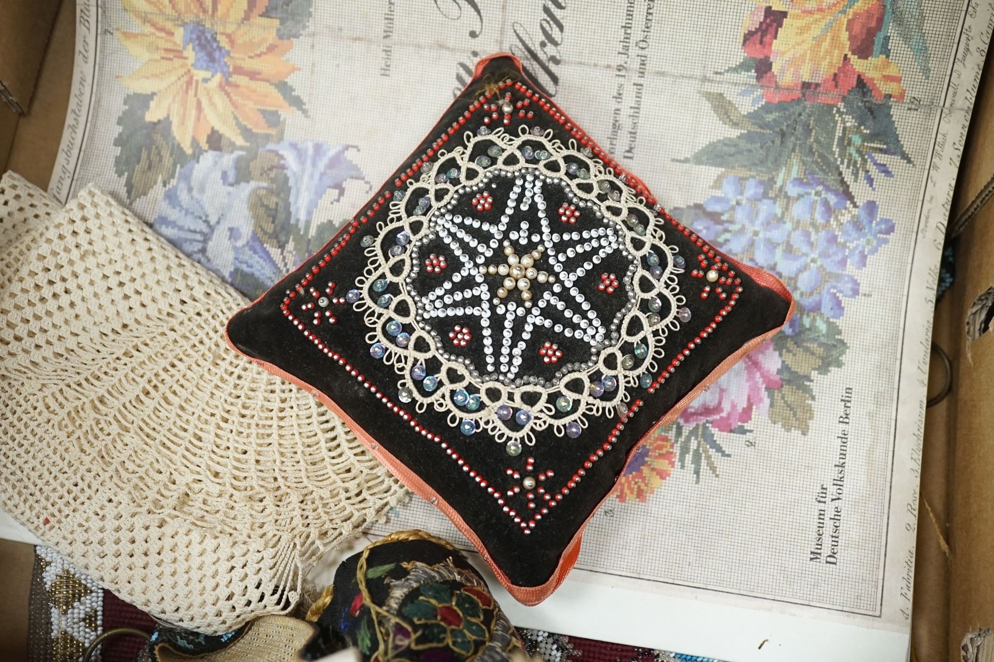 A Berlin beadwork panel , another, a beaded cushion, a book and embroidered banners, 2 silk panels etc
